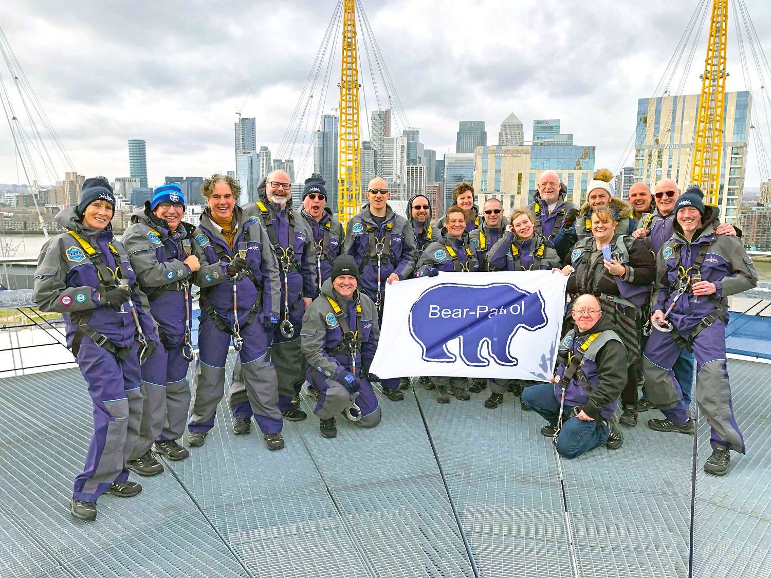 The Bear Patrol team stand on top of the O2 roof, having completed the challenge of walking across the roof.